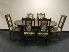 A Priory oak oval extending dining table with leaf and six single chairs