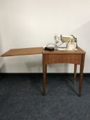 A Singer electric sewing machine and teak table