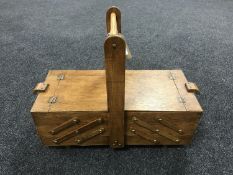 A mid twentieth century oak concertina sewing box