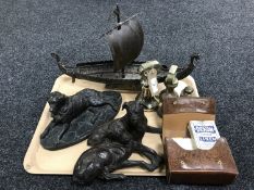 A painted metal Viking longboat, two resin figures of dogs, 19th century brass weights,