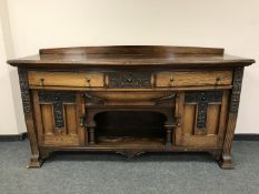 An Arts & Crafts style bow fronted sideboard,