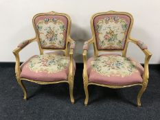 A pair of gilt salon armchairs upholstered in a floral tapestry fabric