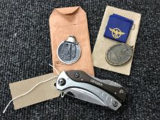 Two German Third Reich copy medals and a Gerber folding pocket knife