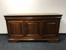 A contemporary triple door sideboard, fitted three drawers above,