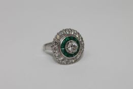 An emerald and diamond cluster ring,