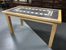 A contemporary rectangular beech table with a tiled panelled insert