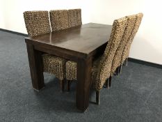 A contemporary nine piece hardwood dining room suite comprising of a sideboard,