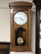 An early 20th century mahogany cased wall clock with enamelled dial