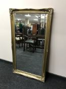 A gilt framed bevel edged overmantel mirror