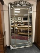 An ornate silvered rectangular mirror, 100 cm x 198 cm.