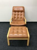 A late twentieth century beech framed relaxer armchair and stool in brown leather