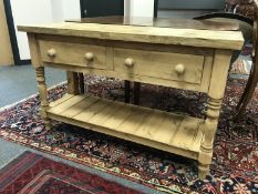 A reclaimed pine two drawer side table,