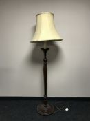 A contemporary standard lamp with shade