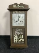 A painted cased wall clock bearing sign writing advertisement 