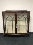 A mahogany double door display cabinet on claw and ball feet