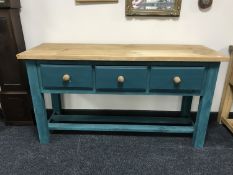 A reclaimed pine kitchen prep table fitted with three drawers on painted base