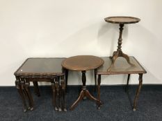 A nest of three mahogany glass topped tables together with one mahogany glass topped table and two