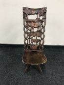 A carved African birthing chair