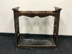 An oak Art Nouveau stick stand with metal tray