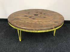 A reclaimed cable drum topped coffee table on metal legs