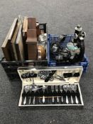 Two crates containing assorted framed pictures, wooden wall racks, metal letter openers, cameras,