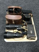 A tray of three sets of binoculars,