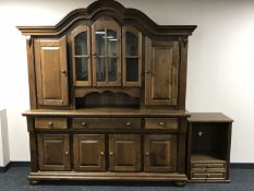 A heavy oak shaped topped four door dresser in a continental style on bun feet,