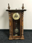 A late Victorian walnut wall clock with enamelled dial,