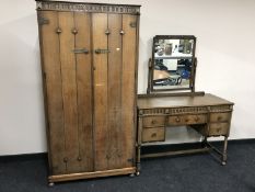 An oak bedroom suite consisting of a double door gentleman's wardrobe and a kneehole dressing table