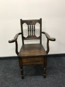 A late Victorian mahogany commode armchair