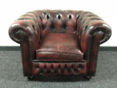 A red button leather Chesterfield style club armchair