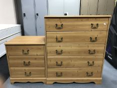 A pine effect five drawer chest,