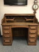 A 1920's oak roll top desk,