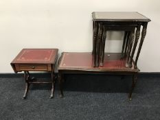 A mahogany red leather glass topped coffee table together with matching nest of three tables and a
