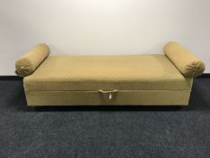 A mid twentieth century storage day bed with two bolster cushions