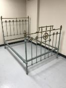 A painted Victorian cast iron and brass 4''6 bed frame