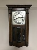 A oak cased eight day wall clock with silvered dial