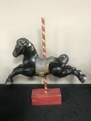 A mid twentieth century children's horse on stand in the form of a carousel horse