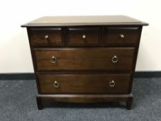 A Stag five drawer chest in mahogany finish