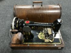 A mid twentieth century oak cased Singer sewing machine