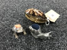 A seashell case containing a sterling silver novelty pin cushion in the form of a frog and one