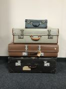 Four vintage luggage cases together with a metal snooker cue case