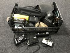 A basket containing assorted cameras, camera bags, tripod,
