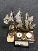 A tray containing two wooden models depicting galleons, a brass replica Titanic ships bell,