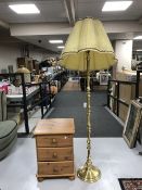 A pine bedside chest and a brass standard lamp with shade