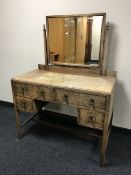An Edwardian oak dressing table fitted four drawers