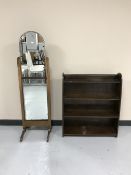 A set of open bookshelves together with a cheval mirror