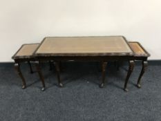 A mahogany glass and leather topped coffee table fitted two tables beneath