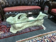 An ornate 'Mermaid' glass topped coffee table, 127 cm x 76 cm.