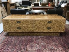 A low four drawer sideboard in a walnut finish